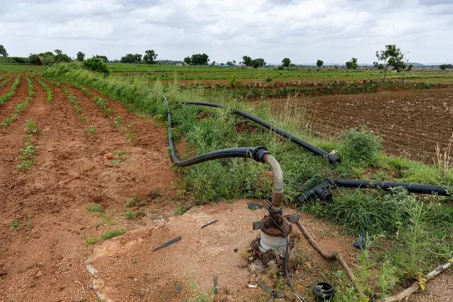 A real borewell head and irrigation pipes in a cotton field in Raichur, Karnataka.
