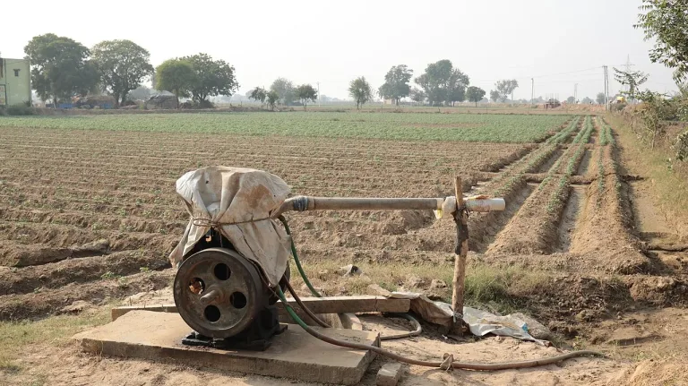 A real surface irrigation pump arrangement beside crop fields in Vrindavan, Uttar Pradesh.